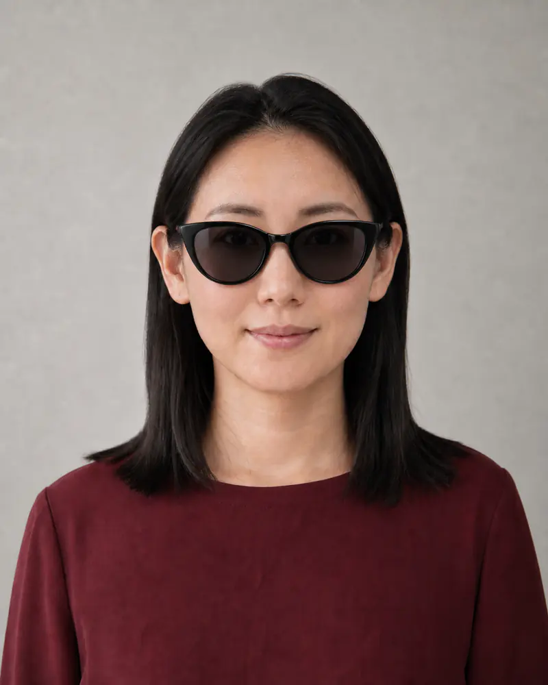 Same woman wearing black cat-eye sunglasses with smoke lenses