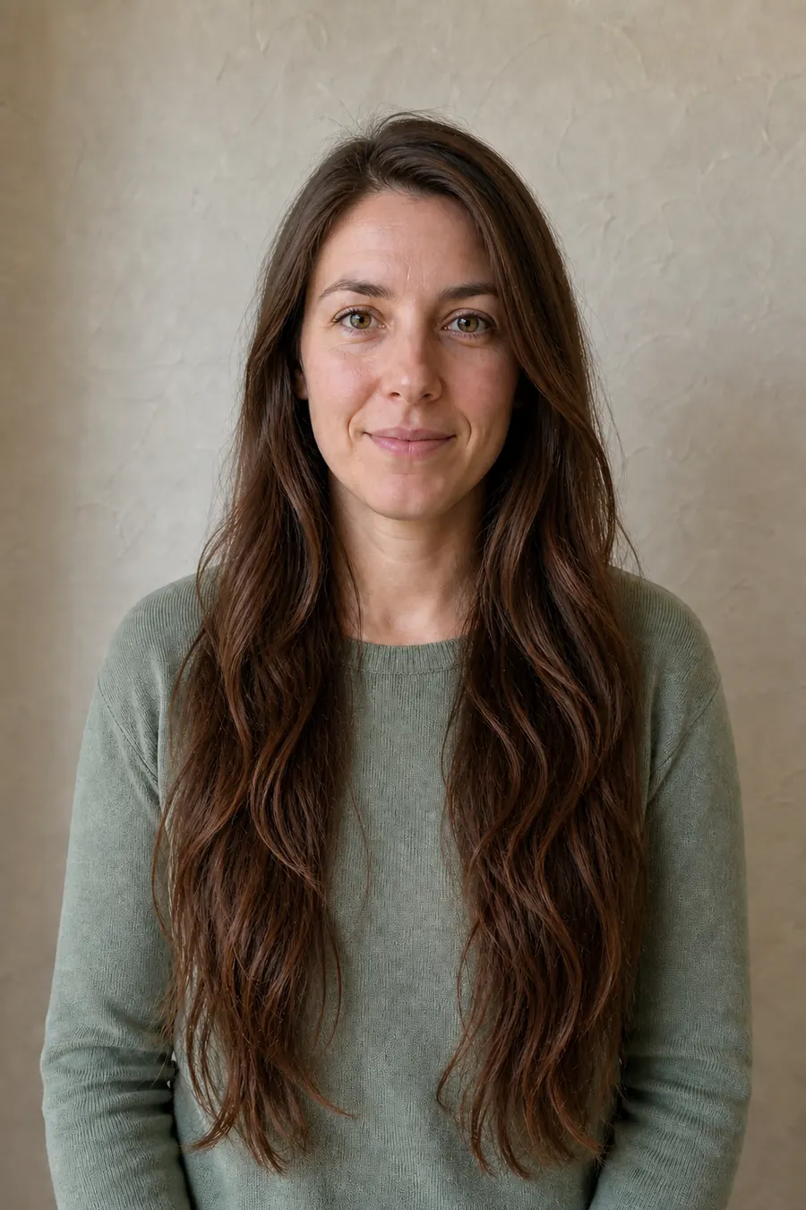 Same woman with long blended chestnut layers, face-framing pieces, and soft natural waves after an AI hairstyle preview